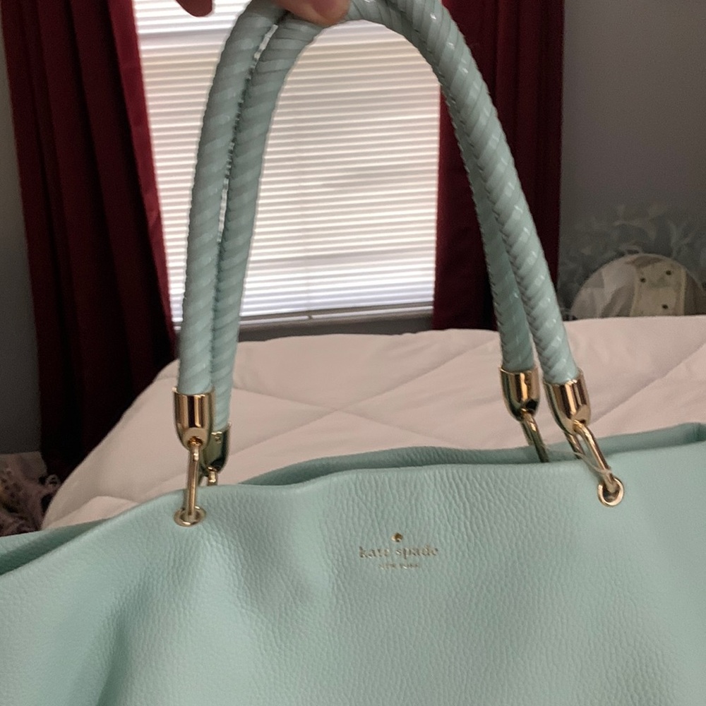 Never used great color! I will Throw  in the little change purse !